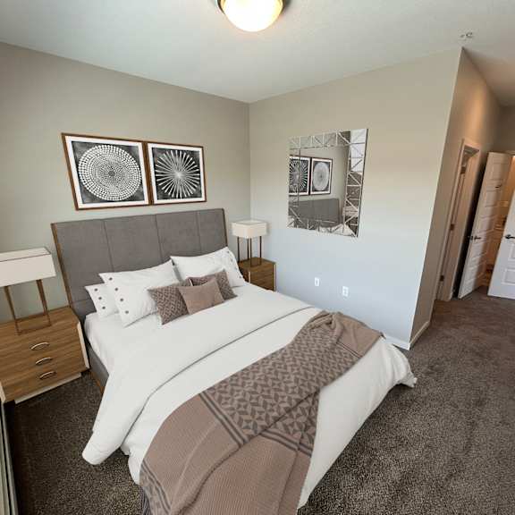 a bedroom with a large bed and two lamps.