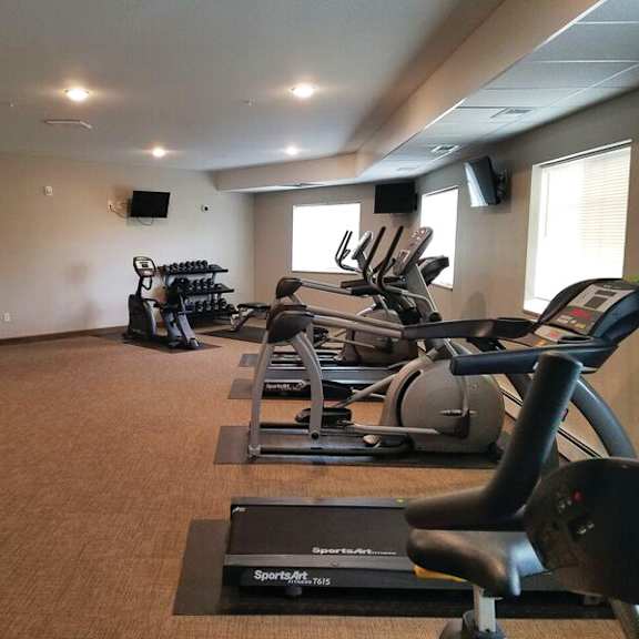 a gym with treadmills and elliptical machines.