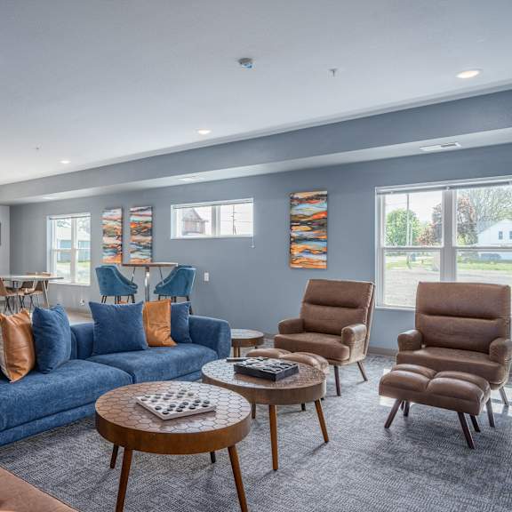 a living room with a blue couch and chairs