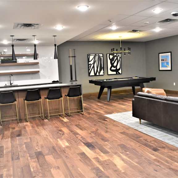 a room with a pool table and a couch.
