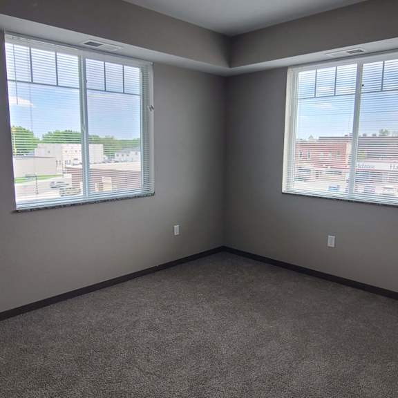 an empty room with three windows
