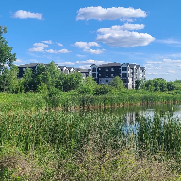a building with a crane in front of a body of water