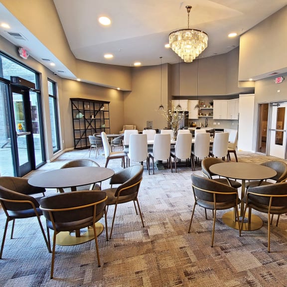a large room with tables and chairs and a piano