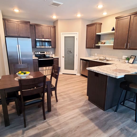 a kitchen and dining area with a table and chairs