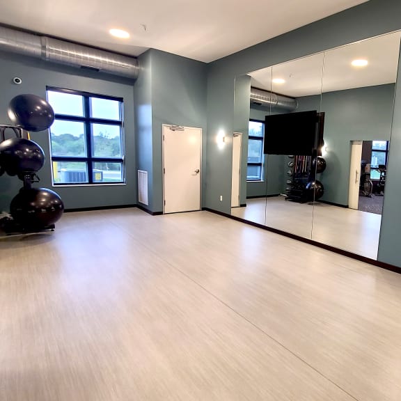 an empty room with paintings on the wall and a wooden floor