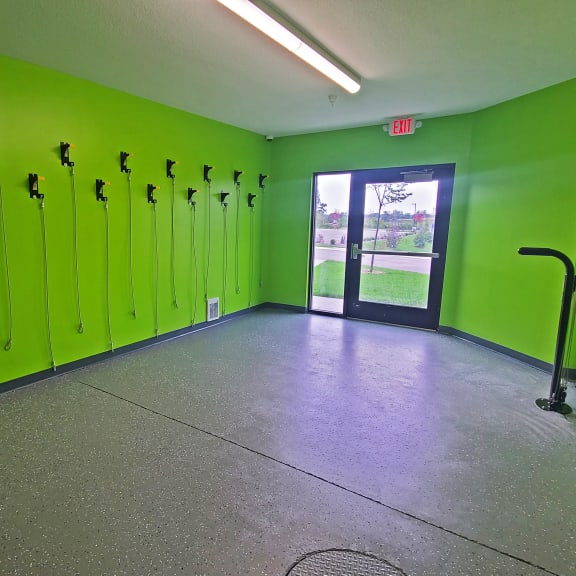 a large room with green lockers and a concrete floor