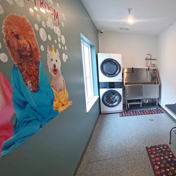 a laundry room with a washing machine and a blue table