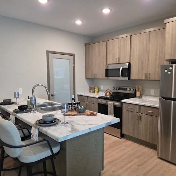 a modern kitchen with a dining table set for four.