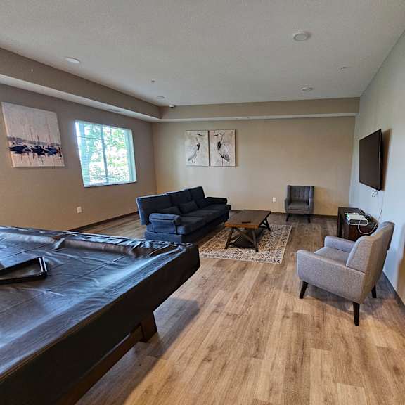 a living room with a blue sofa and a grey armchair.