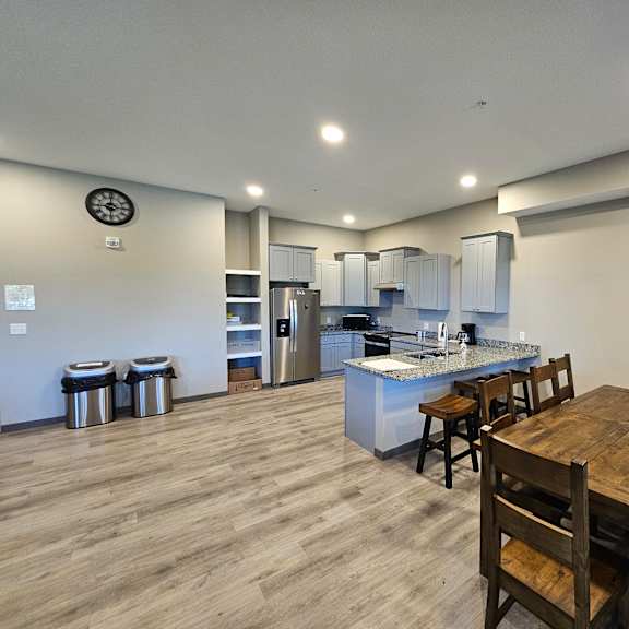 a kitchen with a wooden table and chairs.