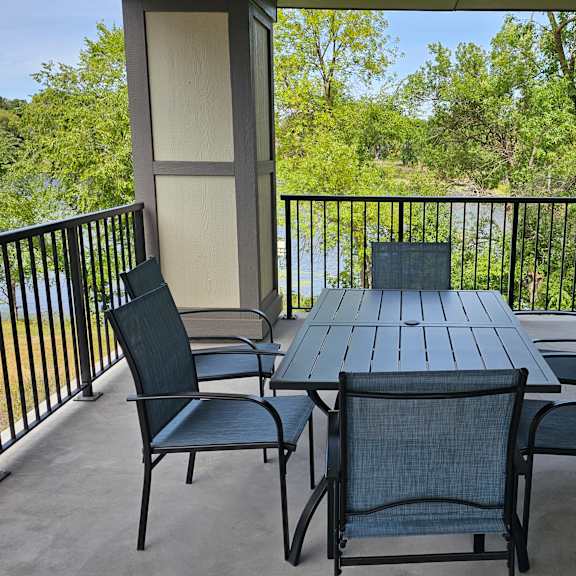 a table and chairs set on a balcony.