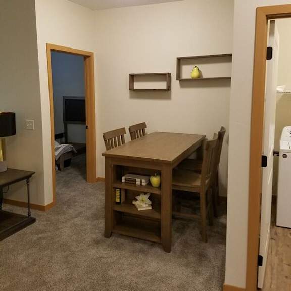 a small dining room with a table and chairs.