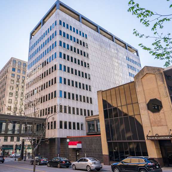 a city street with cars and buildings.