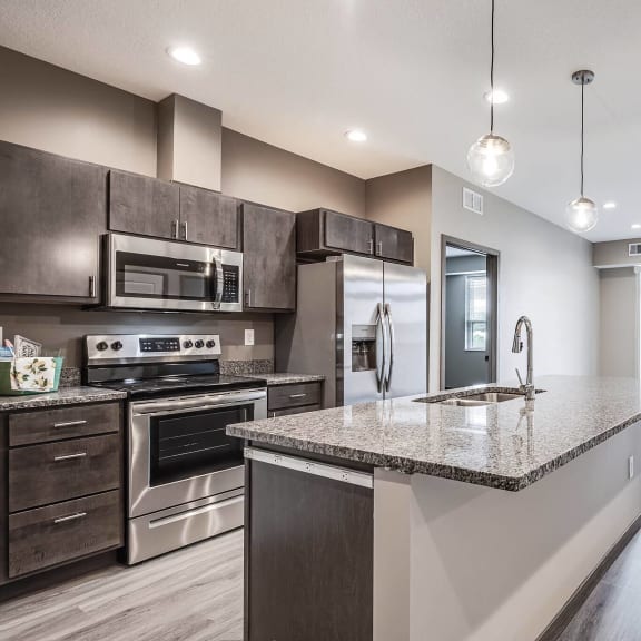 a kitchen with stainless steel appliances and a granite counter top