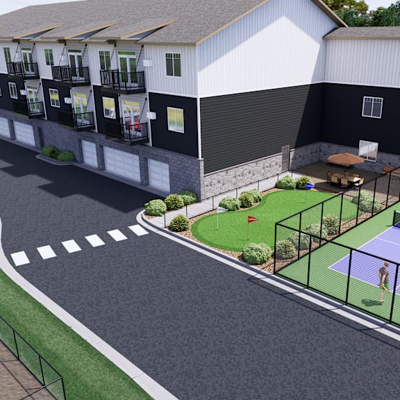 a tennis court is located in front of a white building.