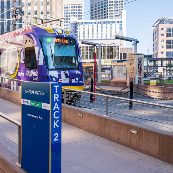 a train on the green line tracks at a station.