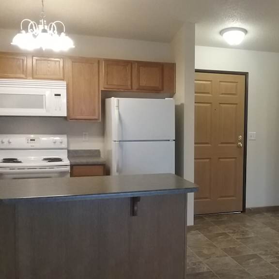 a kitchen with a refrigerator, stove, and oven.