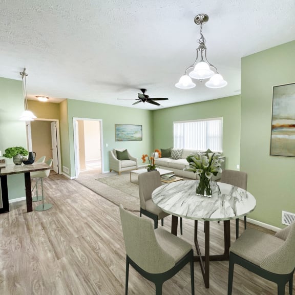 a living room and dining room with a table and chairs