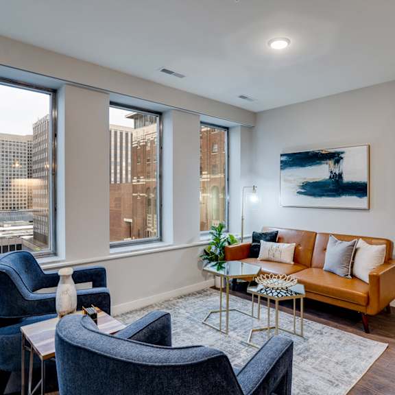 a living room with a couch, chairs, and a coffee table.