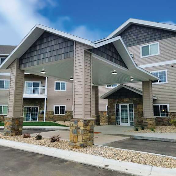 a modern two-story residential building with a covered entrance.