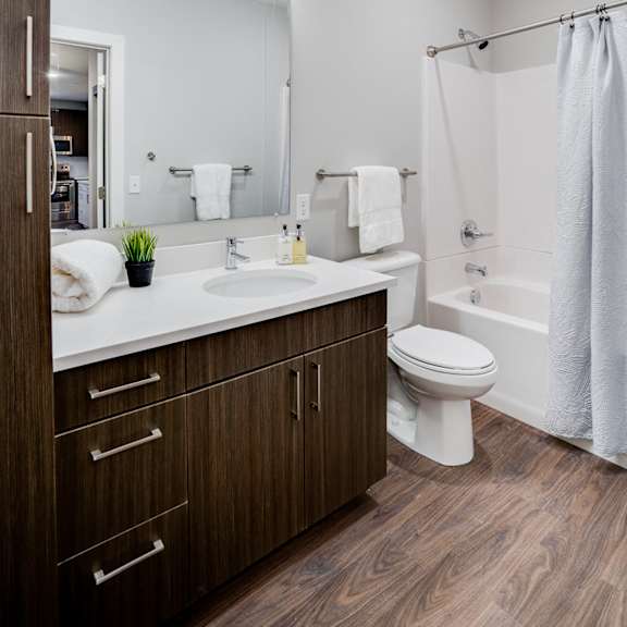 a modern bathroom with a white toilet and a white sink.