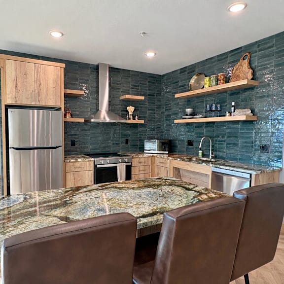 a kitchen with a large island and a refrigerator.
