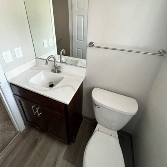 a bathroom with a toilet sink and a mirror
