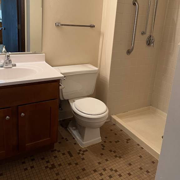 a bathroom with a toilet and a shower.