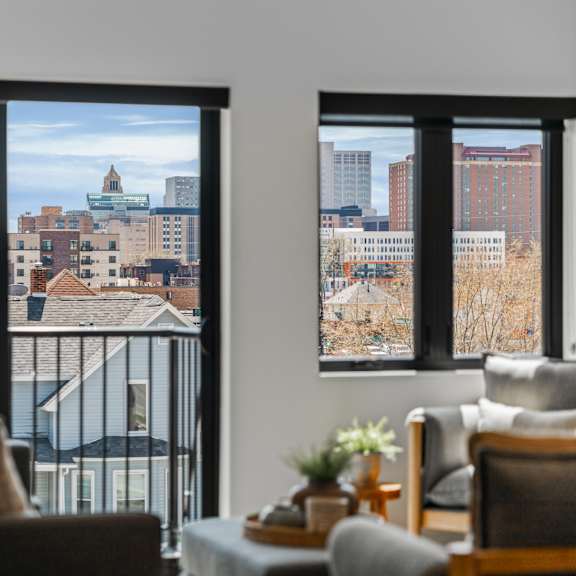 a living room with a view of the city through the windows.