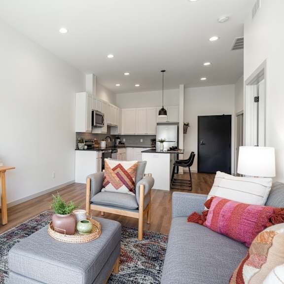 a living room with a grey couch and a wooden table.