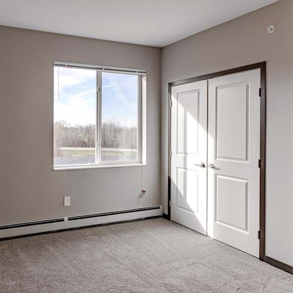 an empty room with a door and a window