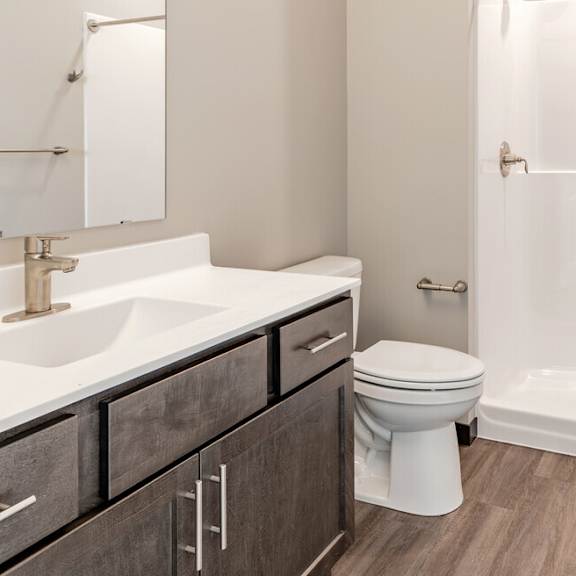 a bathroom with a sink toilet and shower