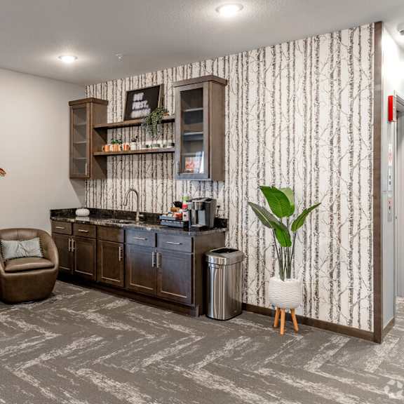 the living room of a home with a counter and chairs