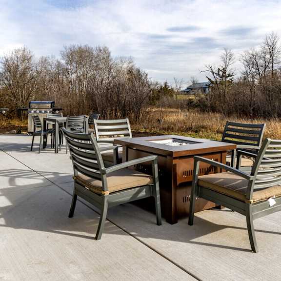 a patio with chairs and a table on a patio