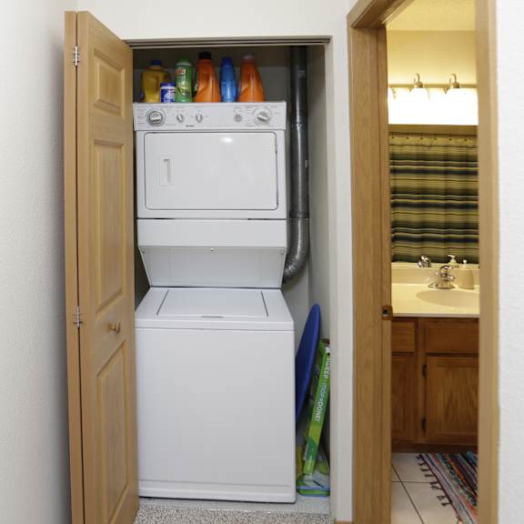 a small kitchen with a white fridge and a white washing machine.
