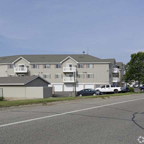 apartment complex with a parking lot in front.