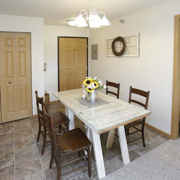 a dining room with a table and chairs.