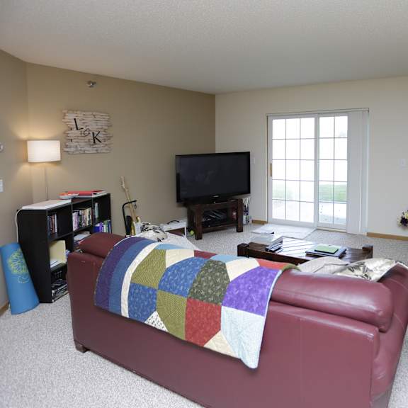 a living room with a red couch and a television.