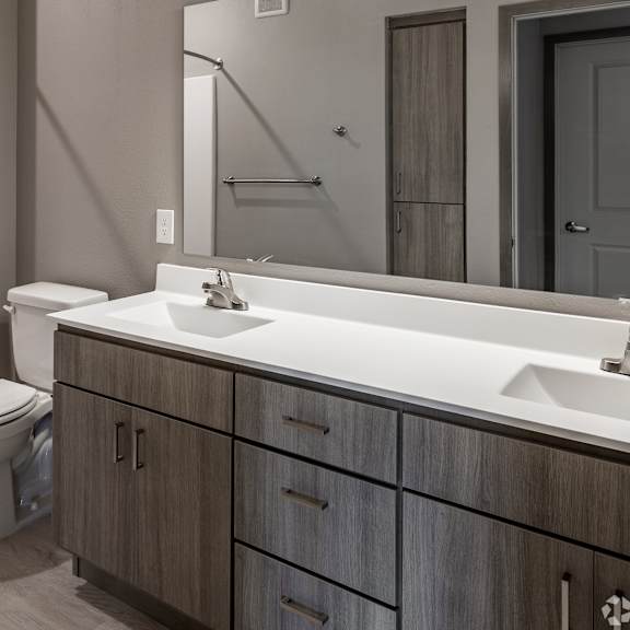 a modern bathroom with a white sink and a white bathtub.
