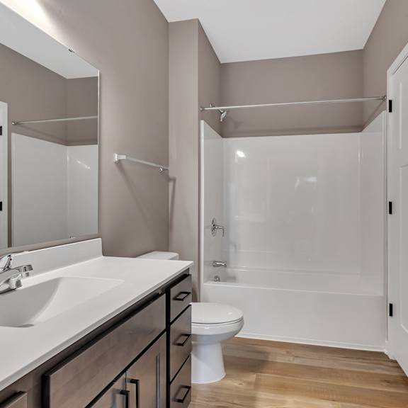 a bathroom with a white sink and a white toilet.