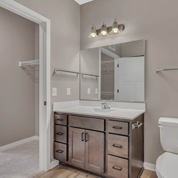 a white toilet sits next to a sink in a bathroom.