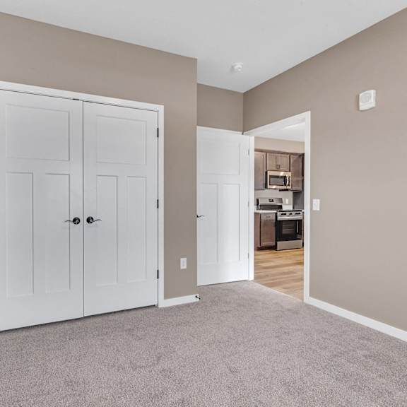 a room with a white door and a carpeted floor.