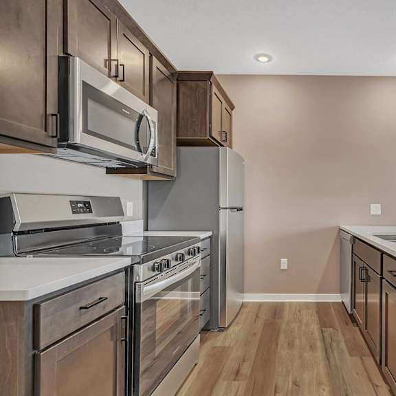 a kitchen with a stove top oven and microwave.