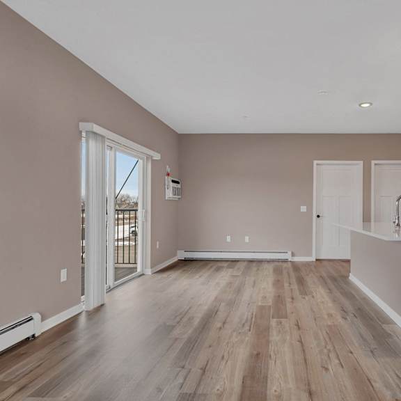 a room with wooden floors and white walls.