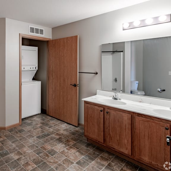 a bathroom with a sink and a tub and a shower and a mirror