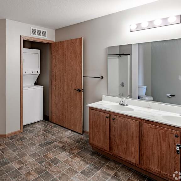 a bathroom with a sink and a tub and a shower and a mirror