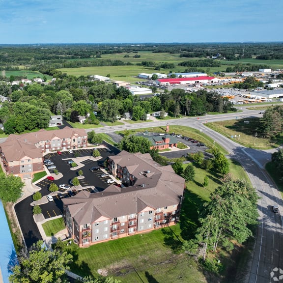 an aerial view of a large estate with houses and a parking lot