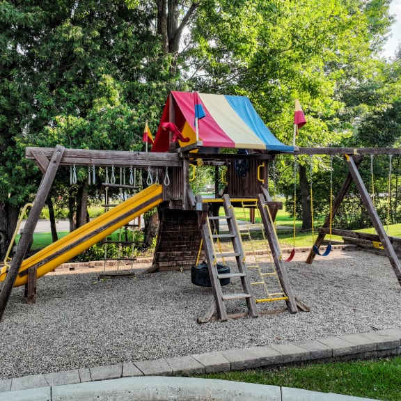 a swing set on the playground in a park