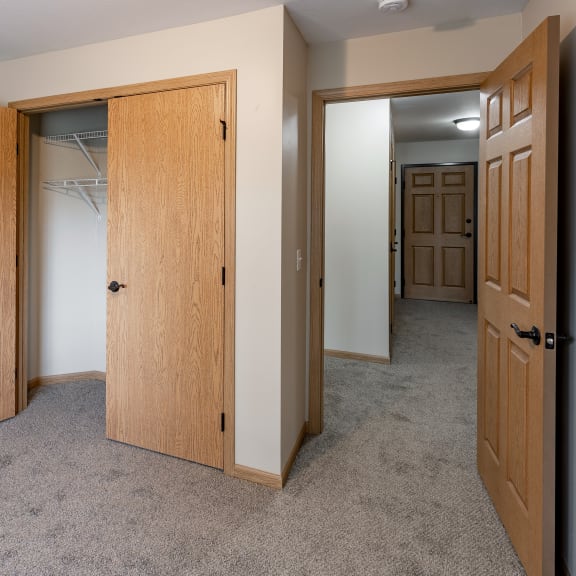 a bedroom with a closet and a door to a bathroom