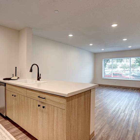 a kitchen with a sink and wooden cabinets.